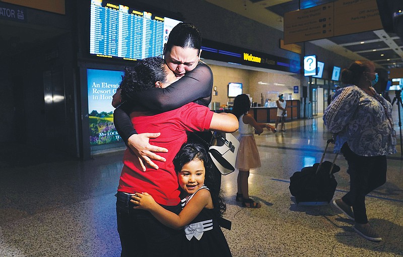 Emely, left, is reunited with her mothe Glenda Valdez and sister, Zuri, Sunday at Austin-Bergstrom International Airport. It had been six years since Valdez said goodbye to her daughter Emely in Honduras. Then, last month, she caught a glimpse of a televised Associated Press photo of a little girl in a red hoodie and knew that Emely had made the trip alone to the United States. On Sunday, the child was returned to her mother's custody.