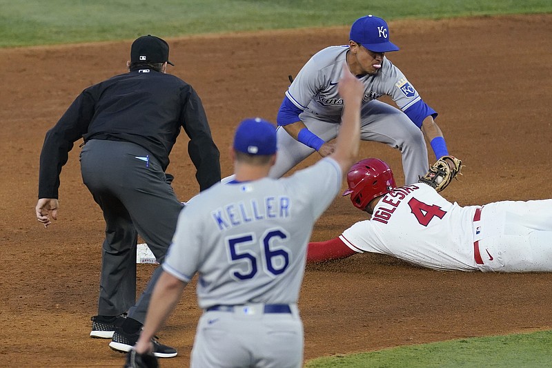 Royals shortstop Nicky Lopez tags out Jose Iglesias of the Angels during the fourth inning in Wednesday night's game in Los Angeles as Royals relief pitcher Brad Keller celebrates.