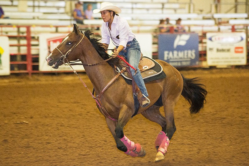 Katy Pendergrass races her horse Whocaughtcha during the 2017 Runnin' WJ Barrel Race at Four States Fairgrounds.