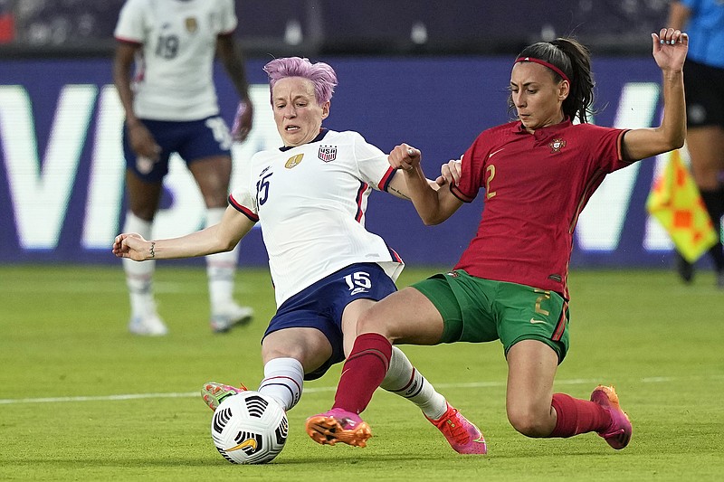The United States' Megan Rapinoe (left) and Portugal's Catarina Amado slide for the ball during the first half of Thursday's international friendly match in Houston.