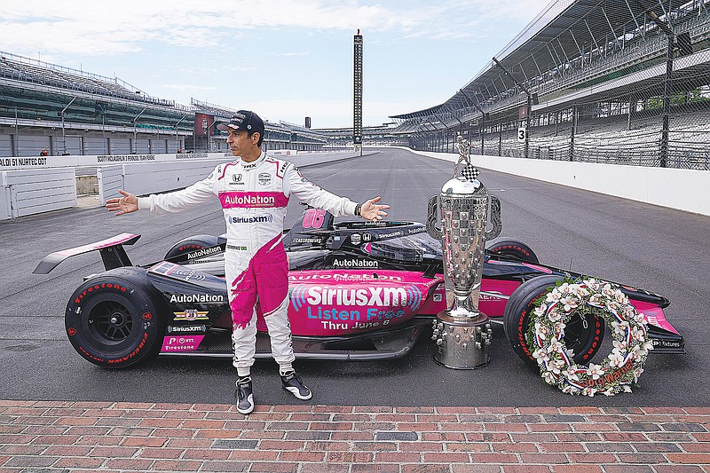 In this May 31 file photo, Helio Castroneves poses during the traditional winner's photo session at the Indianapolis Motor Speedway in Indianapolis.