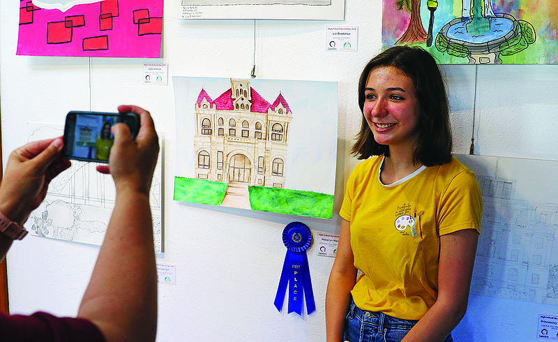 Jefferson City High School student Makailyn Mantle stands next to her first-place submission into the beginner category of the High School Sketch Day contest Thursday evening at Capital Arts. 