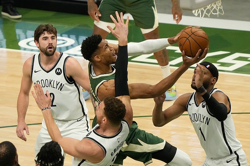 Milwaukee Bucks' Giannis Antetokounmpo shoots past Brooklyn Nets' Bruce Brown and Blake Griffin during the first half of Game 3 of the NBA Eastern Conference basketball semifinals game Thursday, June 10, 2021, in Milwaukee. (AP Photo/Morry Gash)