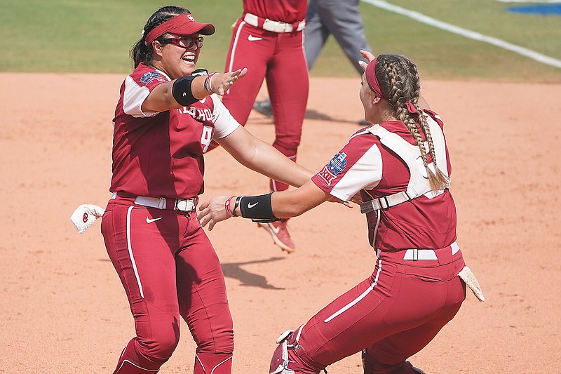 Oklahoma pitcher Giselle Juarez celebrates Thursday with catcher Kinzie Hansen after the Sooners defeated Florida State in the final game of the = Women's College World Series in Oklahoma City.