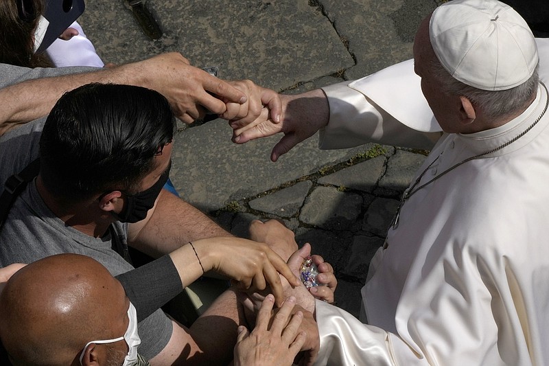 Pope Francis is greeted by faithful during his weekly general audience in the San Damaso courtyard, at the Vatican, Wednesday, June 9, 2021. (AP Photo/Alessandra Tarantino)