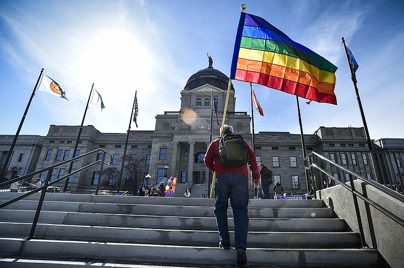 FILE - In this March 15, 2021, file photo, demonstrators gather on the steps of the Montana State Capitol protesting anti-LGBTQ+ legislation in Helena, Mont. Gov. Greg Gianforte signed a bill Friday, May 7, 2021, banning transgender athletes from participating in school and university sports according to the gender with which they identify, making Montana one of several Republican-controlled states to approve such measures in 2021. (Thom Bridge/Independent Record via AP, File)=MTHEL