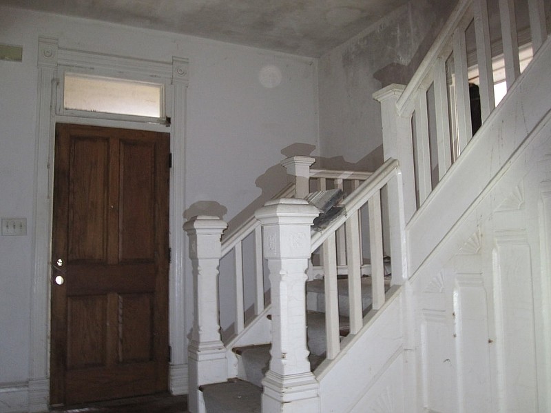 Previous owners had painted the wooden staircase white, but during rehabilitation the family uncovered the wood and took it back to its original appearance.