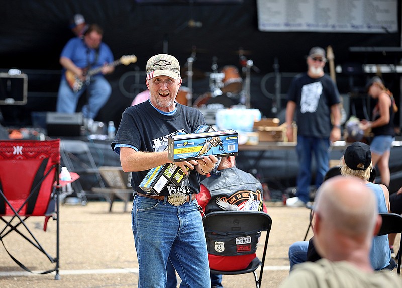 Items are auctioned Saturday afternoon during Benefit for Blake in downtown Texarkana, Ark. The event was held to raise money for 2-year-old Blake Sampson who is being treated for a serious head injury in a Dallas hospital. In addition to the auction, there was live music, a car and bike show, a raffle and a poker run.