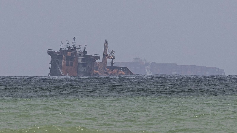 FILE - In this Friday, June 4, 2021, file photo, the fire-damaged container ship MV X-Press Pearl is seen partially sunk where it is anchored off Colombo port at Kapungoda, Sri Lanka. Sri Lanka is seeking an interim claim of $40 million from the operator of a fire-ravaged cargo ship to cover the cost of fighting the blaze, officials said Saturday, June 12. (AP Photo/Eranga Jayawardena, File)