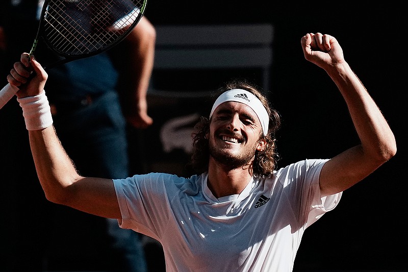 Stefanos Tsitsipas of Greece raises his arms as he defeats Germany's Alexander Zverev in their semifinal match of the French Open tennis tournament at the Roland Garros stadium Friday, June 11, 2021 in Paris. (AP Photo/Thibault Camus)