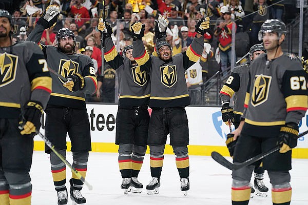 Golden Knights teammates William Karlsson and Keegan Kolesar celebrate with teammates Thursday night after defeating the Avalanche to win an NHL playoff series in Las Vegas.