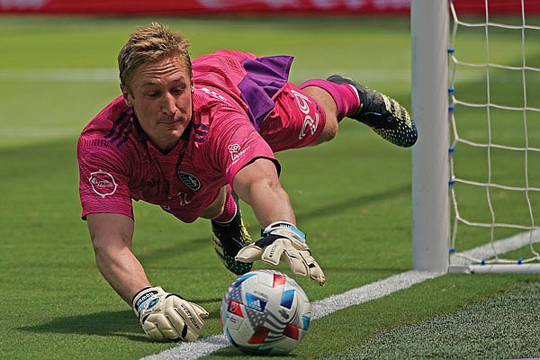 Sporting Kansas City goalkeeper Tim Melia dives to keep the ball inbounds during the first half of Saturday afternoon's MLS match against the Austin FC in Kansas City, Kan.