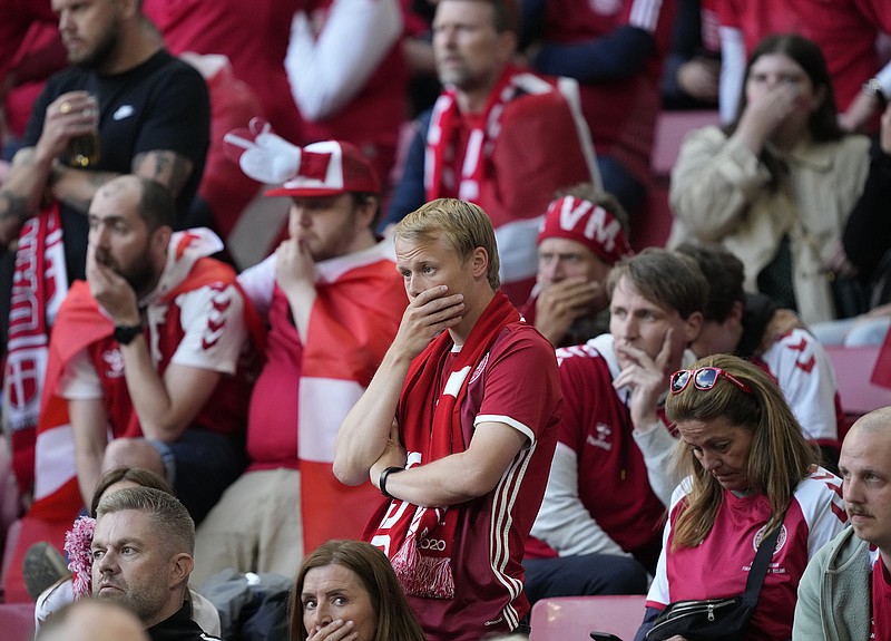 Denmark fans react as Christian Eriksen receives medical attention after collapsing during the Euro 2020 group B match Saturday against Finland in Copenhagen.