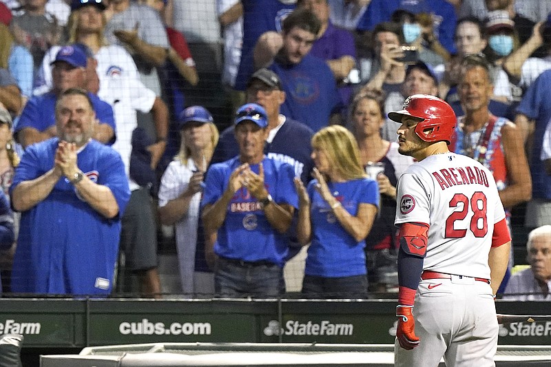Nolan Arenado of the Cardinals looks toward the field as he walks to the dugout after being called out on strikes during the ninth inning of Sunday night's game against the Cubs in Chicago.