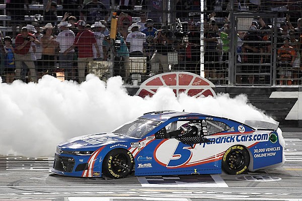 Kyle Larson celebrates on the front stretch after winning Sunday night's NASCAR Cup Series All-Star race at Texas Motor Speedway in Fort Worth, Texas.