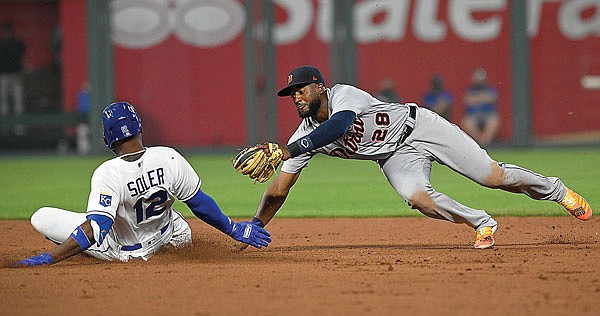 Jorge Soler, left, slides safely into second past the tag by Tigers shortstop Niko Goodrum for a double during the fifth inning of Monday's baseball game in Kansas City.