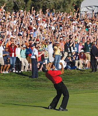 In this June 15, 2008, file photo, Tiger Woods celebrates after sinking a birdie putt on the 18th green, forcing a playoff against Rocco Mediate during the fourth round of the U.S. Open at Torrey Pines in San Diego.