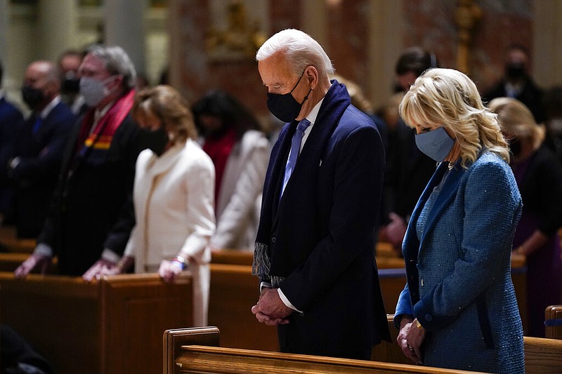 In this Wednesday, Jan. 20, 2021 photo, President-elect Joe Biden and his wife, Jill Biden, attend Mass at the Cathedral of St. Matthew the Apostle during Inauguration Day ceremonies in Washington.