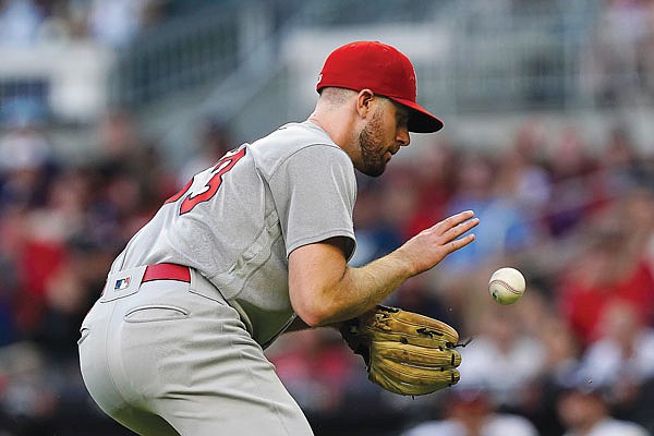 Cardinals starting pitcher John Gant fields a ball hit to him by Freddie Freeman of the Braves in the third inning of Thursday night's game in Atlanta.