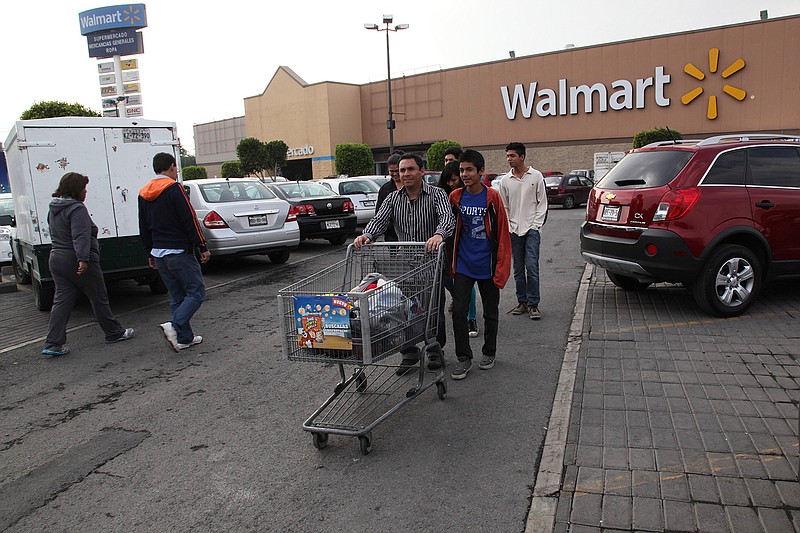 In this file photo, a family leaves a Walmart in Mexico City. (AP Photo/Marco Ugarte, File)