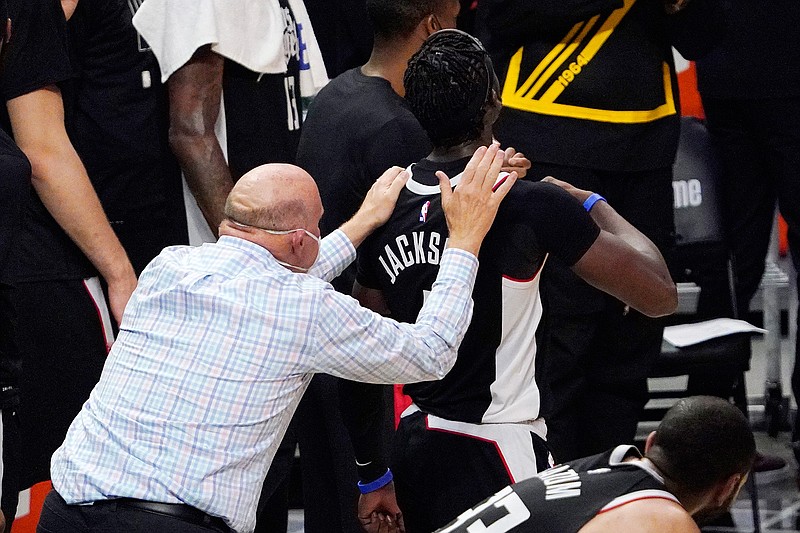 Los Angeles Clippers owner Steve Ballmer pats guard Reggie Jackson on the back after the Clippers defeated the Utah Jazz 131-119 in Game 6 of a second-round NBA basketball playoff series against the Utah Jazz Friday, June 18, 2021, in Los Angeles. (AP Photo/Mark J. Terrill)