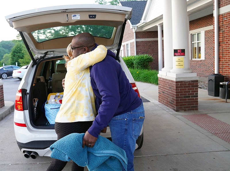 Tonya Rhoden, left, hugs her husband, Aaron, before he heads in for dialysis at Fresenius Medical Care on June 11, 2021, in Naperville, Illinois. (Stacey Wescott/Chicago Tribune/TNS)