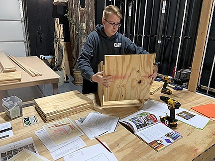 California High School junior Treston Lewis works on a Little Free Library. Lewis, the Art Club president at CHS for the upcoming school year, has worked together with other CHS students this summer to complete the library boxes to be placed throughout the county on behalf of the Moniteau County Library and Central Missouri Community Action. Other students that have aided with the project include Gwen Yarnell, an outgoing senior and the club's former president. (Submitted photo)