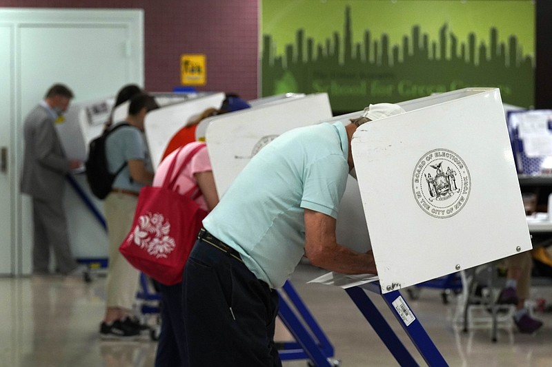 Voters mark their ballots at Frank McCourt High School, in New York, Tuesday, June 22, 2021. The final votes are set to be cast Tuesday in New York's party primaries, where mayors, prosecutors, judges and city and county legislators will be on the ballot, along with other municipal offices. (AP Photo/Richard Drew)