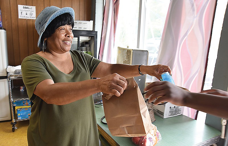 Gloria Brent delivers free lunches to recipients Monday, June 21, 2021, at Second Christian Church in Jefferson City. Brent and other volunteers have committed to providing lunches for area youth who may otherwise miss out on the meal.