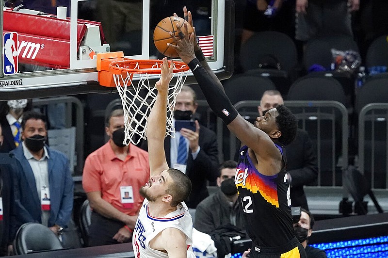 Phoenix Suns center Deandre Ayton, right, scores over Los Angeles Clippers center Ivica Zubac during the second half of Game 2 of the NBA basketball Western Conference Finals, Tuesday, June 22, 2021, in Phoenix. (AP Photo/Matt York)
