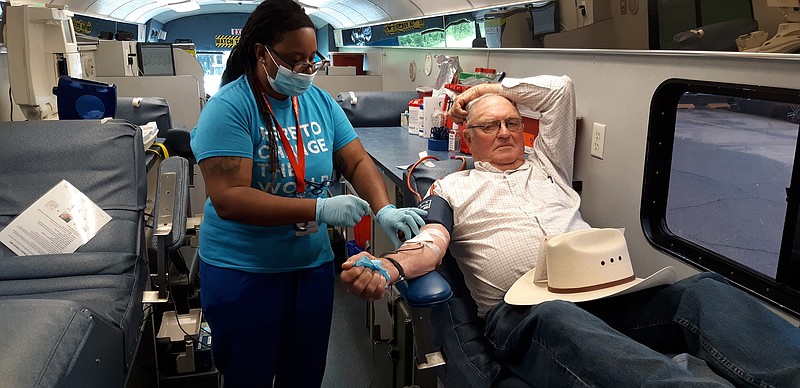  A volunteer donates blood during Carter Bloodcare's blood drive Wednesday at the Dairy Queen on Lake Drive in Texarkana, Texas.