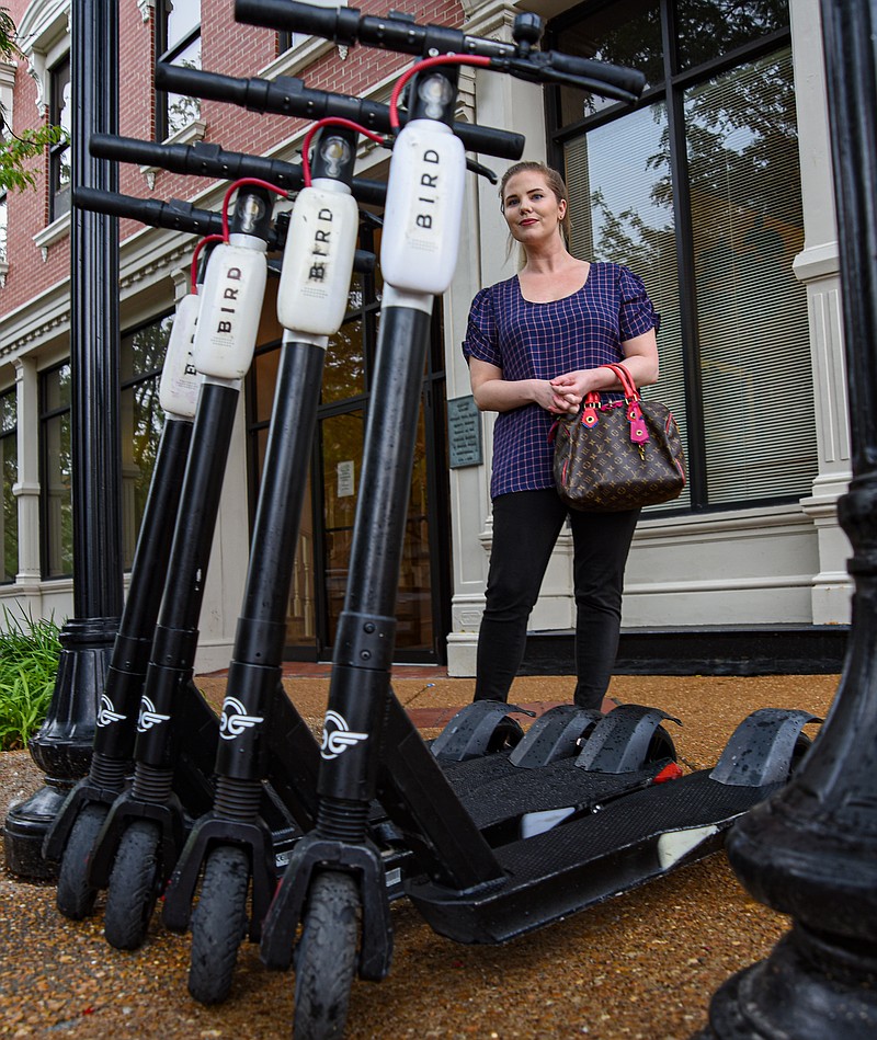 Seen in this June 2021 News Tribune file photo, Megan Sosnowski stops to look at the scooters parked on East High Street in downtown Jefferson City.