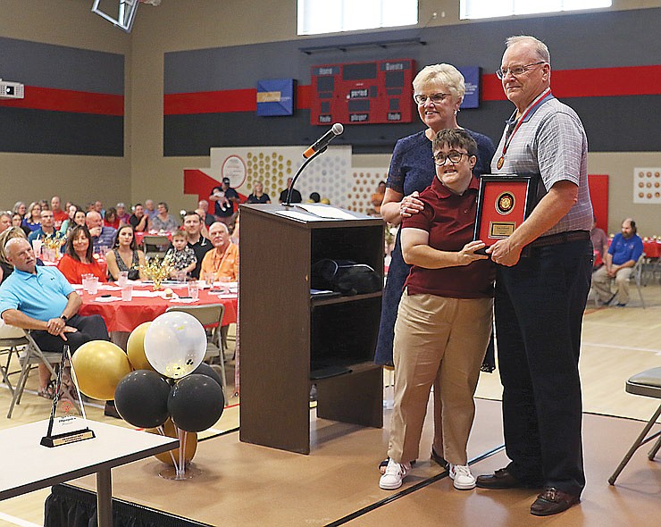 Dave Pudlowski, a former Special Olympics Missouri Board Chairman, gets introduced Saturday afternoon as a 2021 inductee into the SOMO Hall of Fame by Linda Brokamp, left, and Beth Brokamp, center, at the Training for Life Campus.