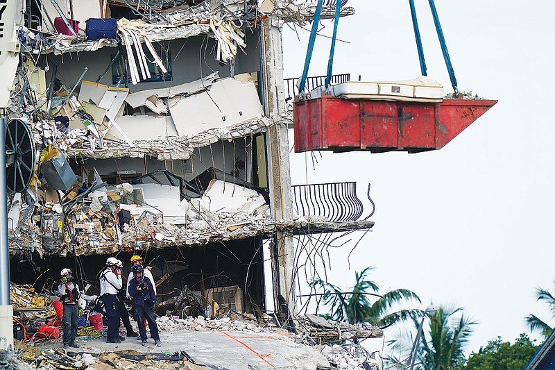 Crews spend fifth day atop a shaky pile of collapsed concrete