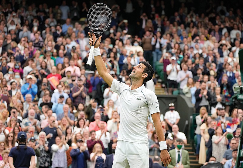 Wimbledon returns to rain, fans, upsets