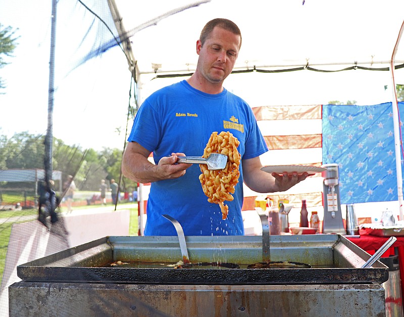 News Tribune fileAdam Nevels with Nevels Brother's Concessions picks up a funnel cake from the fryer during the 2019 Holts Summit Fourth of July celebration.