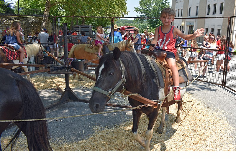 Jaxon Pitman, 6, waves to his parents on Sunday, July 4, 2021, at the Salute to America Festival while riding a pony.