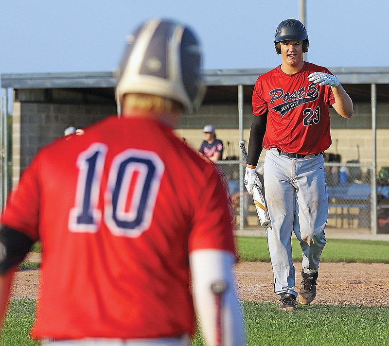 In this July 6, 2021 News Tribune photo, Jace Kesel of the Jefferson City Post 5 Juniors talks to teammate Max Buscher following an at-bat during a game against the Jefferson City Post 5 Freshman team at the American Legion Post 5 Sports Complex.