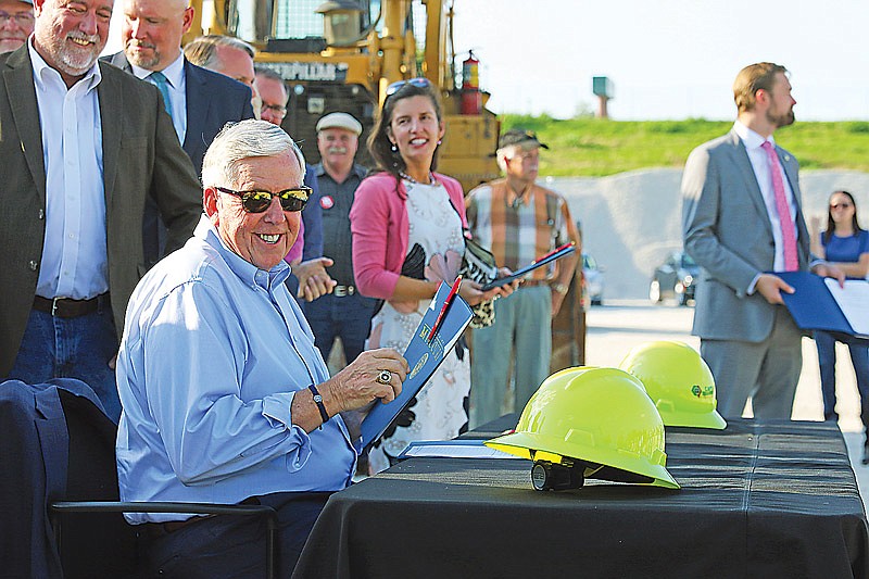 Missouri Gov. Mike Parson smiles Tuesday at Capital Quarries in Jefferson City after signing SB 262, which increases the tax on motor fuel by 2.5 cents in October and 2.5 cents every fiscal year until 2025. 