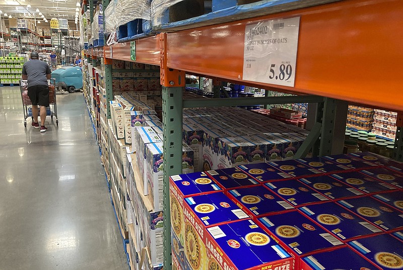 A shopper guides a cart past a line of gigantic boxes of breakfast cereals in a Costco warehouse on Thursday, June 17, 2021, in Lone Tree, Colo. Inflation at the wholesale level jumped 1% in June, pushing price gains over the past 12 months up by a record 7.3%. The Labor Department reported Wednesday, July 14 that the June increase in its producer price index, which measures inflation pressures before they reach consumers, followed a gain of 0.8% in May and was the largest one-month increase since January.  (AP Photo/David Zalubowski)