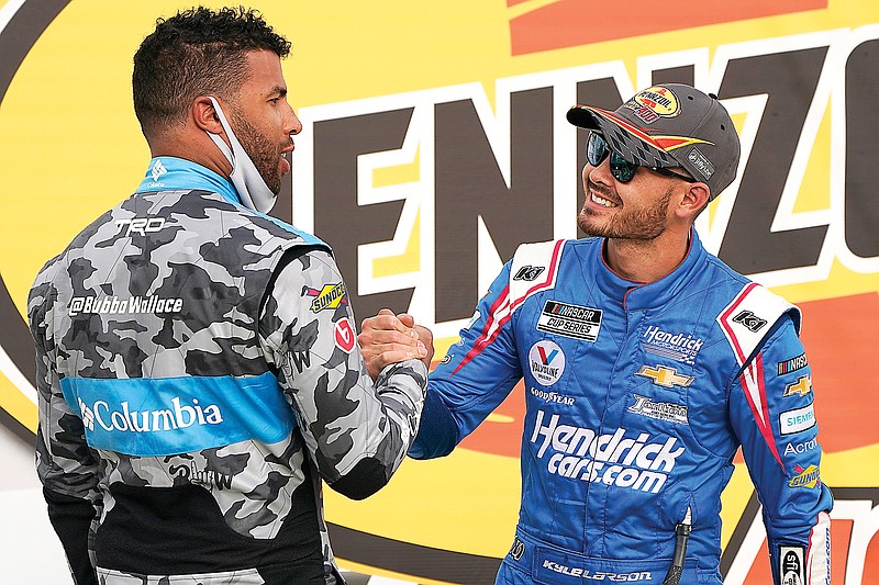 In this March 7 file photo, Bubba Wallace (left) congratulates Kyle Larson after Larson won a NASCAR Cup Series race in Las Vegas. Rick Hendrick has signed Larson to a contract extension through 2023 and Larson will be fully sponsored by HendrickCars.com.