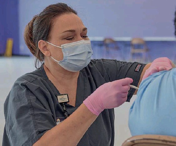 Cyndee Powell, Capital Region Medical Center RN, administers a dose of the Moderna vaccine Thursday, July 15, 2021, at Cole County Health Department's site in Capital Mall in Jefferson City.