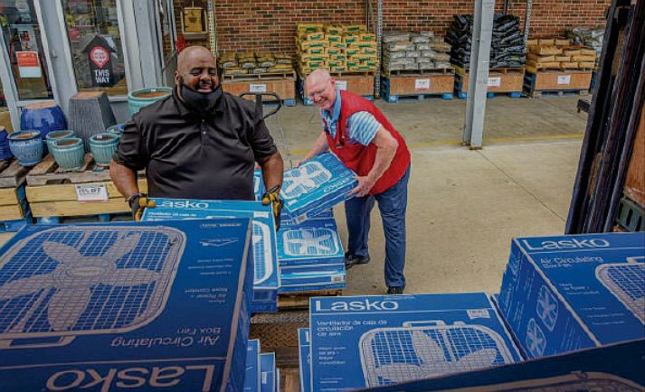 Westlake Hardware Manager Randy Miller helps Lee Dillard, driver for the Salvation Army of Hope, load four dozen box fans into a truck Thursday, July 15, 2021.