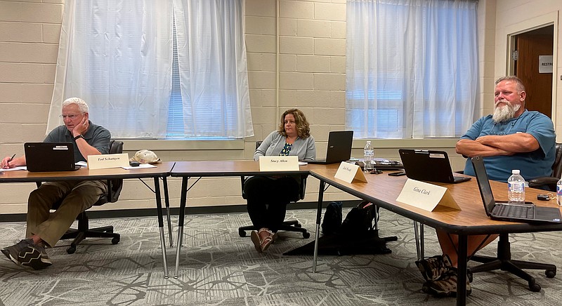 New Bloomfield R-3 Board of Education president Tod Schattgen and board members Stacy Allen and Josh Woods listen Thursday night to COVID-19 and summer project updates during the board's June meeting in the Central Office meeting room in New Bloomfield.