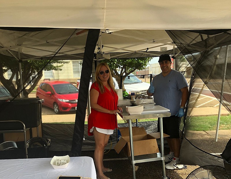 Bren, left, and Ivan Gonzales bring their Cuban cuisine to Texarkana Farmers' Market for the final Cultural Night and the final Night Market of the season. The event was held at 7 p.m. Saturday across from City Hall in downtown Texarkana, Texas. (Photo courtesy of Anne-Marie Sullivan)
