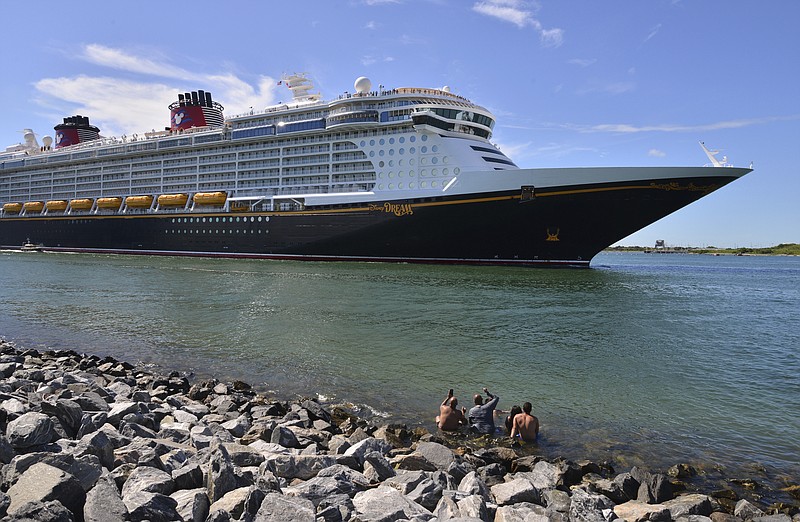 The Disney Dream sails out of Port Canaveral, Fla. on a two night test sailing, also known as a simulation cruise, Saturday, July 17, 2021. The cruise included about 300 Disney cruise employees and their guests. This is the first cruise activity out of Port Canaveral since March of 2020 when cruising was shut down due to COVID-19. (Malcolm Denemark/Florida Today via AP)