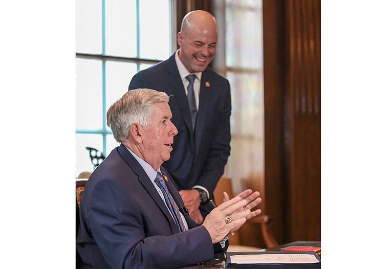 In this July 7, 2021 News Tribune file photo, state Sen. Tony Luetkemeyer, R-Parkville, laughs at a joke made by Missouri Gov. Mike Parson, seated, during a bill signing ceremony in the governor's office. 