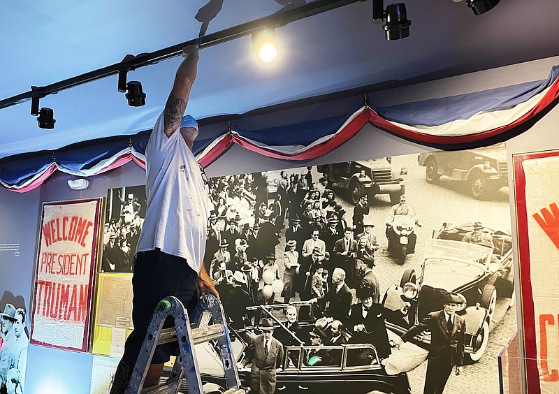 Kendall Rogers — a worker for GloveCon, Inc., in Fulton — does some painting Monday afternoon on the ceiling of the Sinews of Peace/Iron Curtain room at America's National Churchill Museum on the Westminster College campus. The museum will reopen to the public Friday, July 30, with a weekend celebration that will include remarks by Gov. Mike Parson.