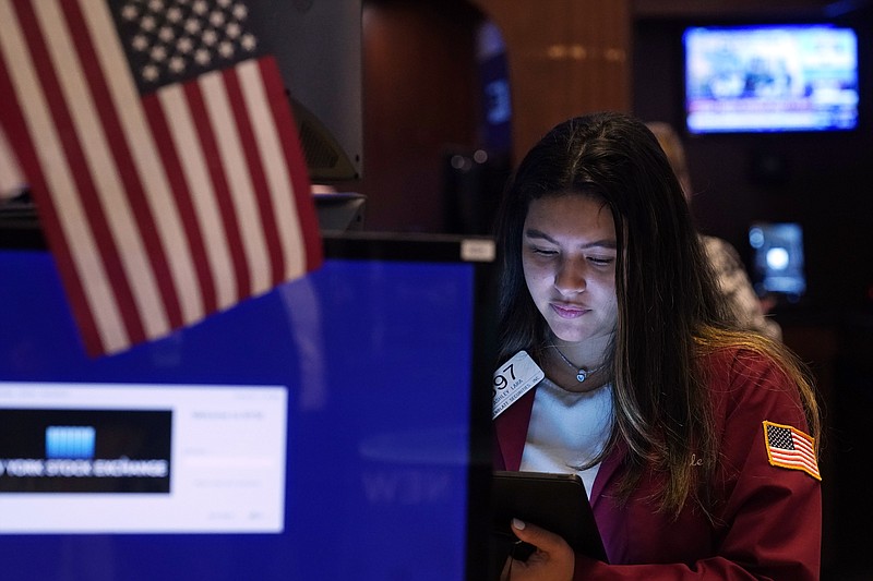 Trader Ashley Lara works on the floor of the New York Stock Exchange, Tuesday, July 20, 2021. Stocks are opening higher on Wall Street Tuesday as investors shake off a rout a day earlier brought on by concerns about the spread of a more contagious variant of COVID-19. (AP Photo/Richard Drew)