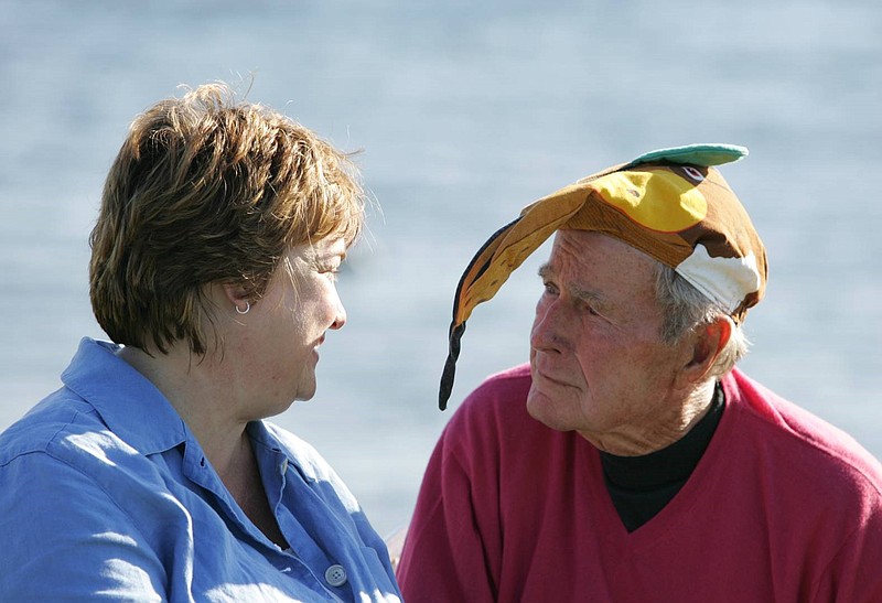 (Courtesy of Jean Becker) Becker speaks with George H.W. Bush, who is wearing an aardvark hat. She learned to always expect the unexpected during her 25 years as President Bush's chief of staff. She's not sure why he wore this hat, or where he got it.